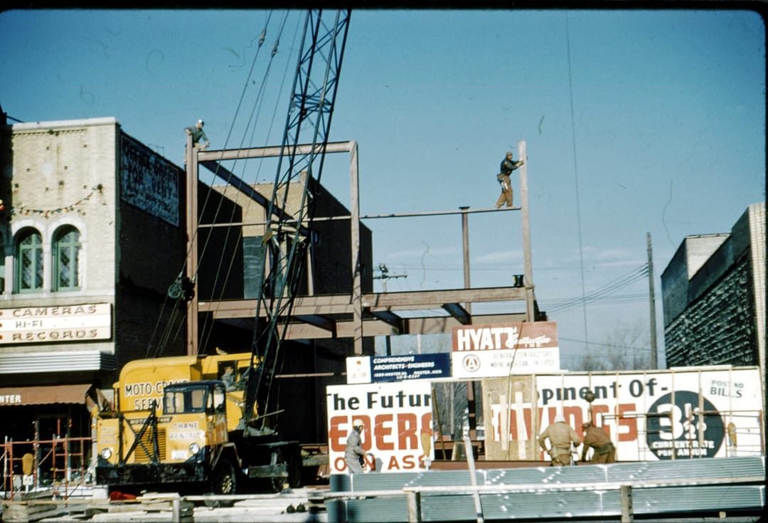 Construction site with crane and steel framework.