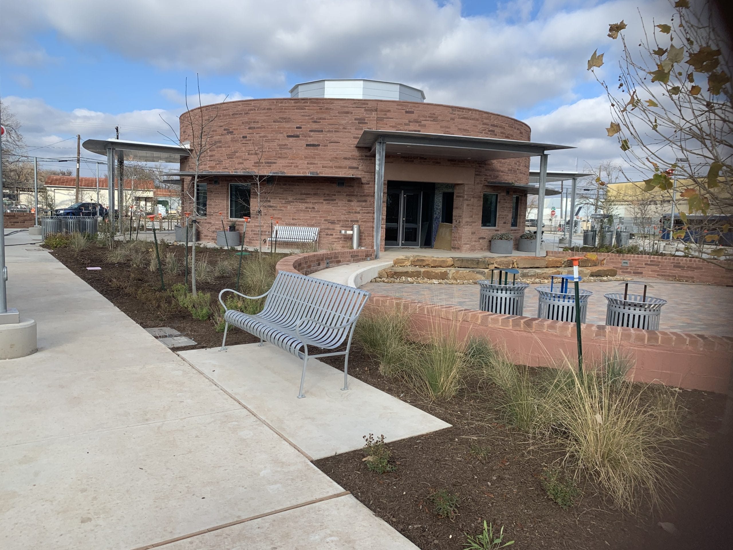 Circular brick building with outdoor seating area.