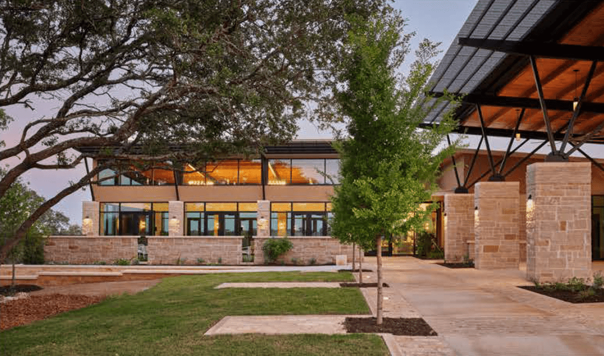 Modern building with trees and pathway outside.