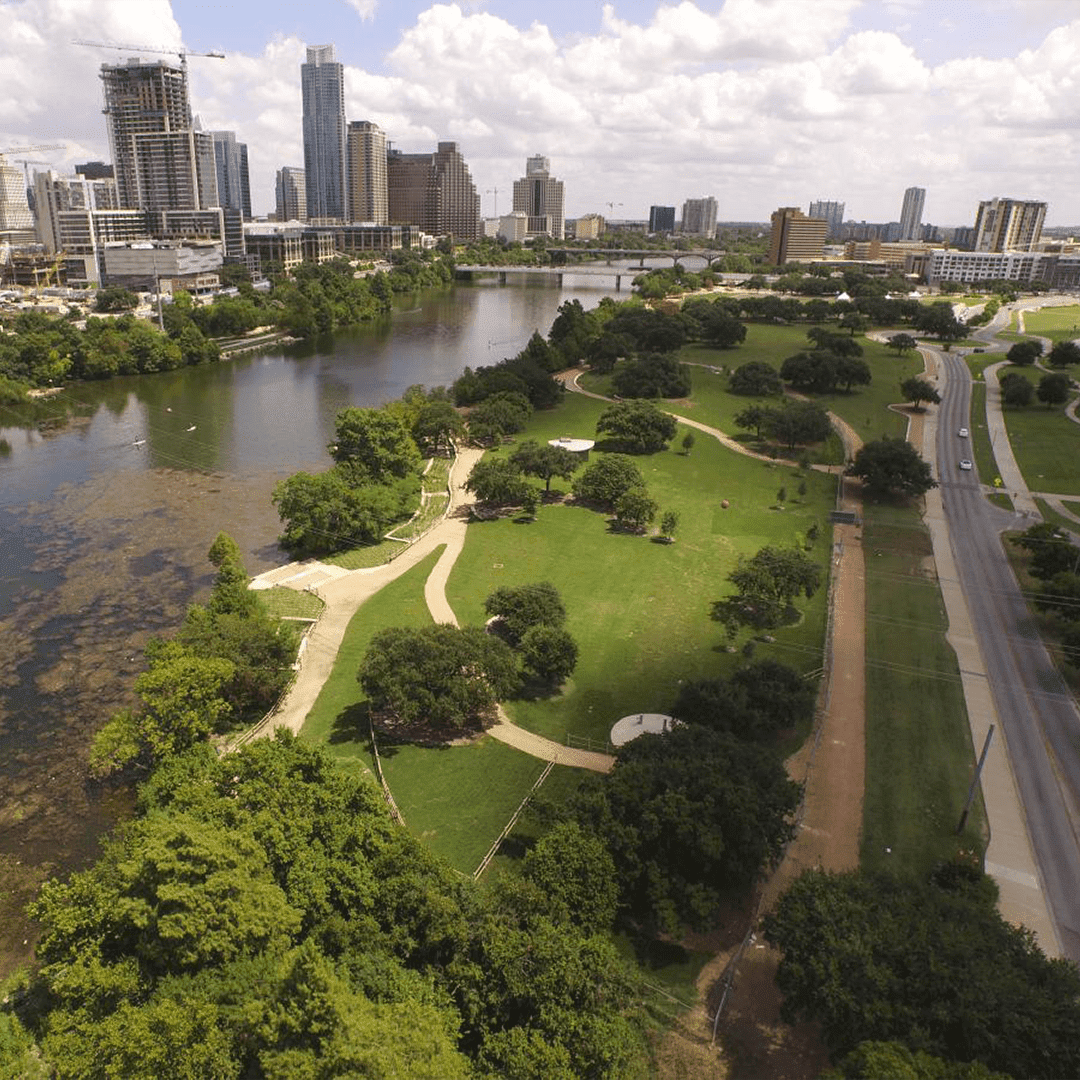 City skyline with river and park view.